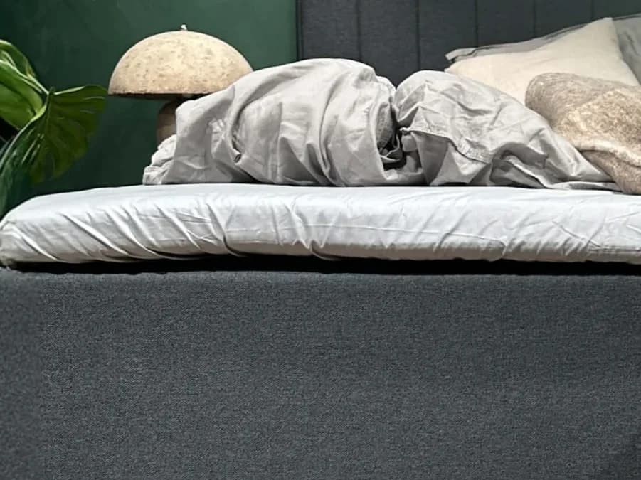 Close-up of the FamBed sheet fitted over the mattress topper on a family bed