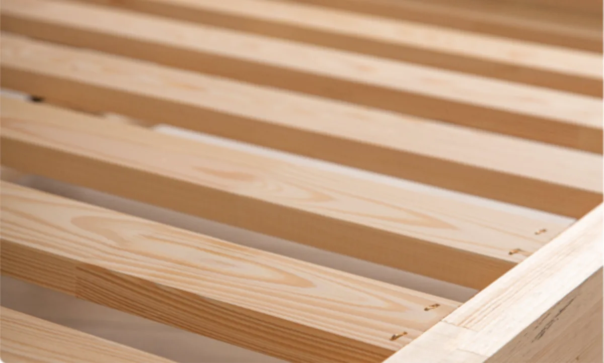 Close-up of the bed frame slats and solid wood edge