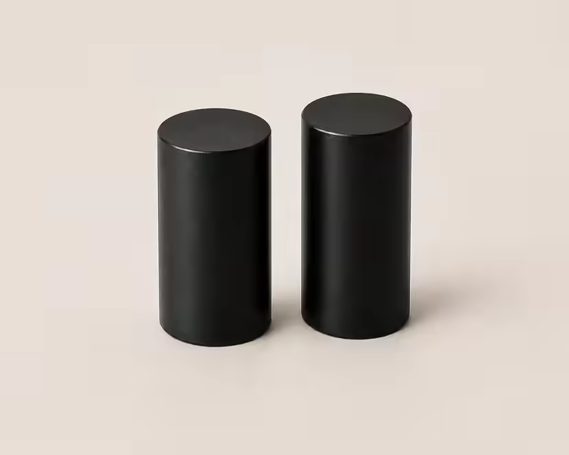 Two black cylindrical centre legs on a light surface